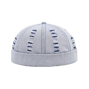 Light blue distressed denim docker cap with vintage frayed holes and retro street style