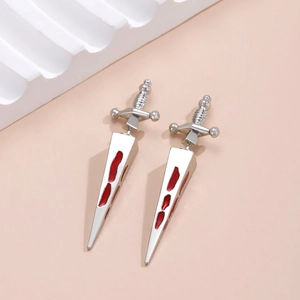 Detailed close-up of gothic silver dagger earrings with red drip oil blood effect