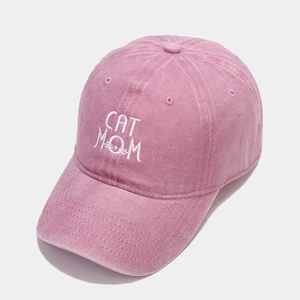 Close-up of CAT MOM embroidery on a pink washed cotton vintage style baseball cap
