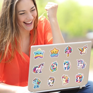 Cute unicorn stickers decorated on a laptop lid held by a person in an outdoor setting