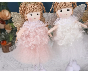 Detail of pink and white knitted angel ornaments with lace wings and glitter finish