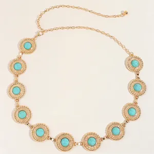 Close-up of bohemian gold metal waist chain with round turquoise inlays for dresses