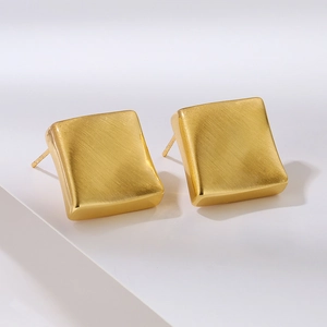 Minimalist square gold stud earrings with a brushed matte finish and geometric design
