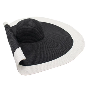 Detail of a large-brimmed straw sun hat with black and white color-block weave design