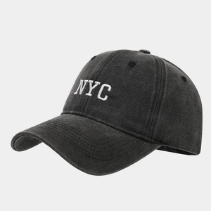 Detail of NYC 3D embroidery on washed vintage cotton baseball cap with high texture