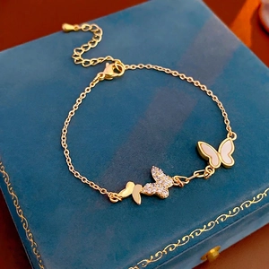 Gold plated butterfly bracelet with zircon and mother of pearl on blue velvet box