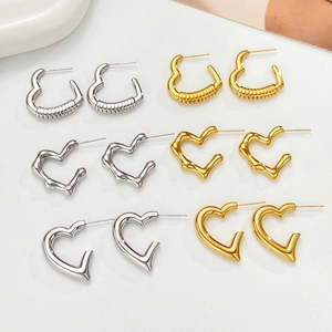 Collection of geometric heart hoop earrings in gold and silver finishes and textures