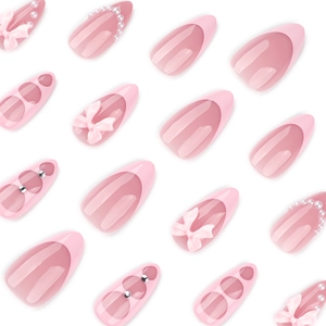 Pink almond press-on nails with 3D bows, pearls, and French tips in an elegant set
