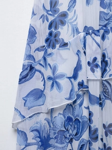 Detailed macro view of the blue floral chiffon fabric with delicate ruffle edge finish