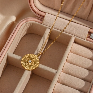 18K gold plated stainless steel sunburst coin necklace with diamond in a pink jewelry box