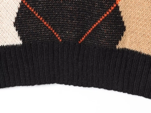 Macro shot of argyle knit pattern and ribbed hem on this stylish sweater vest