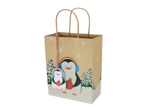 Detail of Christmas kraft gift bag with paper handles and cute penguin tag attachment