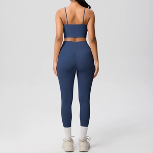 Rear view of navy yoga set featuring strappy sports bra and high-waisted leggings