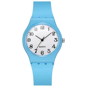 Detailed macro view of the sky blue silicone strap and white analog dial quartz watch