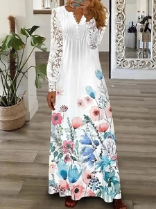 Detail of white lace long sleeves and vibrant floral print on V-neck maxi dress