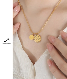 Detail of gold-plated stainless steel necklace with double zircon-set round pendants