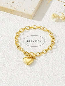 Detailed view of a gold heart pendant bracelet with a T-bar clasp and 20.5cm length label