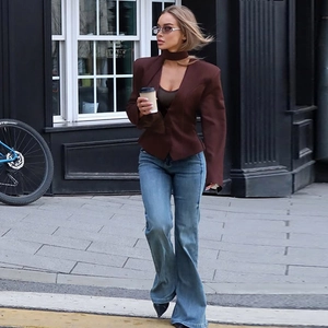 Close-up of slim fit dark brown blazer featuring unique collar cutout and button details