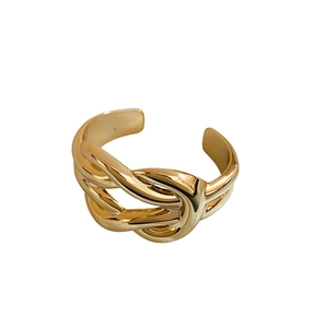 Polished gold-colored wide cross acrylic bracelet with bold minimalist wrap design for women