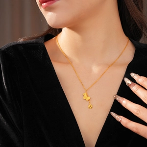 Close-up of a gold-plated horse pendant necklace with a round coin charm on a model