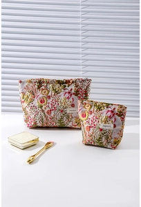 Detail of two vintage floral jacquard cosmetic bags with woven labels and embroidery