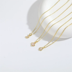 Three-piece gold-toned minimalist necklace set with moon, clover, and Hamsa pendants