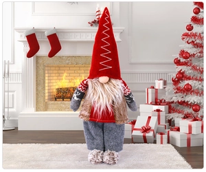 Close-up of a Christmas gnome figurine with red hat and white beard in cozy home setting