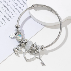 Detail shot of silver charm bracelet with heart, key pendants and sparkling crystal beads