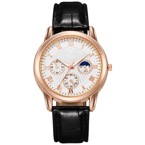 Detail of rose gold case with white roman numeral dial and black leather strap watch