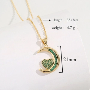 Gold moon and heart necklace with green zircon emerald pendant on white base