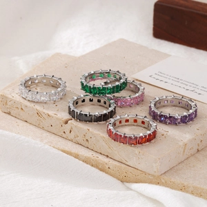 Elegant set of 6 silver titanium rings with colorful square-cut zircon on a stone slab