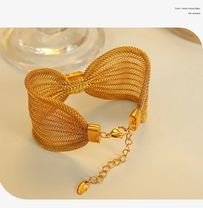 Detailed macro of gold mesh weave stainless steel bracelet with sleek adjustable chain