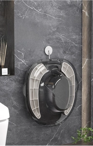 Space-saving grey rimless bidet hanging on marble wall for postpartum care and hygiene