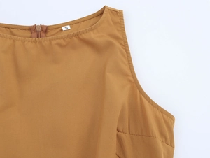 Close-up of brown sleeveless dress neckline with back zipper and small size S label