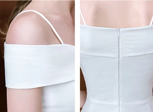 Détail d'une robe en satin blanc montrant les bretelles et la fermeture éclair invisible