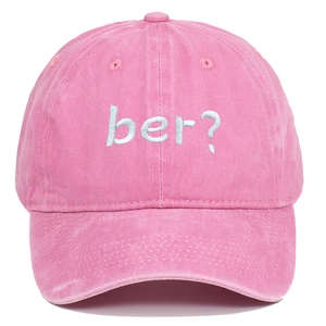 Detailed front view of pink washed cotton baseball cap with blue 'ber?' embroidery