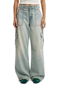Detail showing large utility side pockets and topstitching on wide leg washed denim jeans