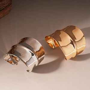 Irregular wide open metal bangles in polished gold and silver finishes with wavy designs