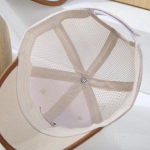 Detail of baby mesh cap with breathable stitching and adjustable velcro strap