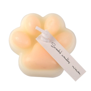 Cat paw shaped scented candle in white and pink soy wax on a clean white background