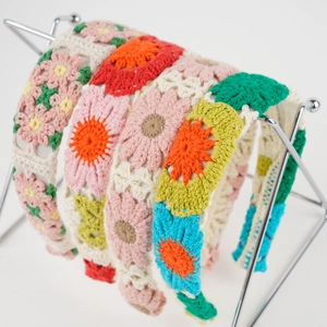 Detailed close-up of a crochet floral headband set in vibrant multi-color handmade knit