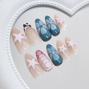 Almond press-on nails set with leopard print, stars, and floral designs on a heart tray