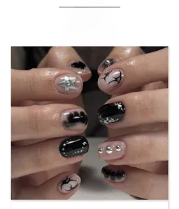 Close-up of gothic Y2K press-on nails with black hearts and silver star details