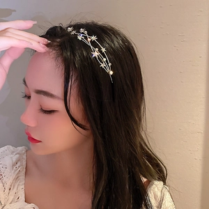 Close-up of elegant silver star headband with rhinestones on a woman's hair
