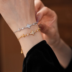 Detailed view of adjustable star-shaped zircon bracelets in gold and silver finishes