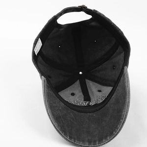 Detailed interior of dark gray washed cotton baseball cap with sweatband and metal buckle