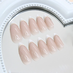 French almond fake nails with pink gradient base and elegant gold edge detailing