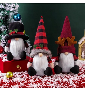 Three Nordic Christmas gnomes with plaid hats and reindeer antlers on a snowy background