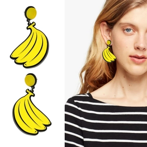 Detail view of yellow banana bunch earrings showing close-up and model wearing style