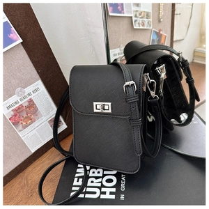 Detail of black cross-pattern faux leather phone bag with silver metallic twist lock closure